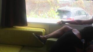 Wife giving risky blowjob in front of window in a camper van