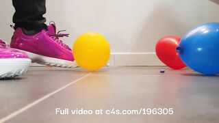 Girl crushing balloons with Fila Disruptor sneakers