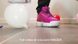 Girl crushing balloons with Fila Disruptor sneakers