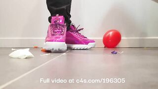 Girl crushing balloons with Fila Disruptor sneakers