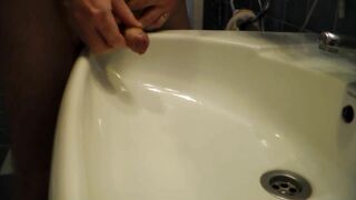 John is Peeing into the Bathroom Sink