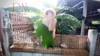 Rural Striptease. Country Girl Dancing in the Yard of her House Rustic Striptease with Banana Leaf