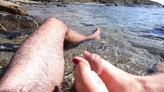 Amateur footjob with cumshot outdoors in a public beach