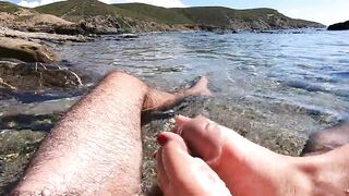 Amateur footjob with cumshot outdoors in a public beach