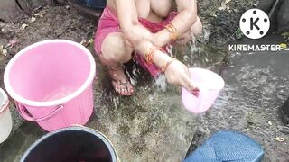 Indian house wife bathing outside