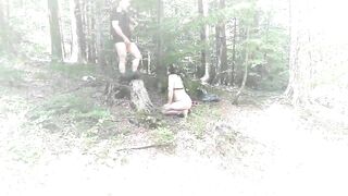 A naked submissive slut crouches in the woods while he pisses on her face