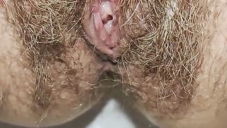 Juicy vagina hides among the curly hair and pisses on your face. In the end you can lick every drop